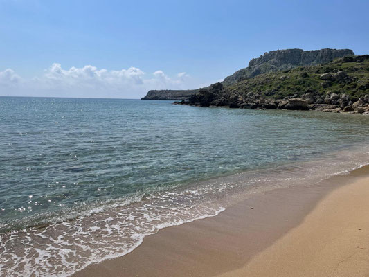 Im vorderen rechten Grund des Fotos ist der goldgelbe Sandstrand des Agathi Beaches zu sehen, dahinter erstreckt sich das Meer und ein Teil der Küste.