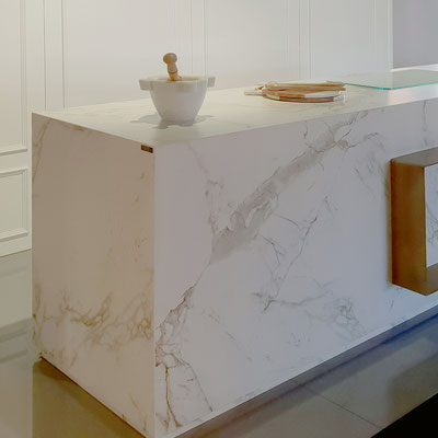 Kitchen island fabricated from classic Neolith Calacatta, reminiscent of white marble with subtle grey veins