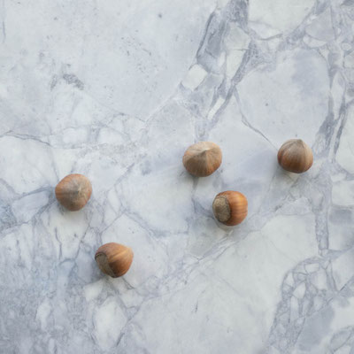 Hazelnuts on light grey marble countertop