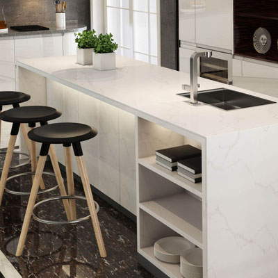Light colored kitchen island with shelves coated with engineered quartz