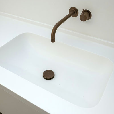 White solid surface washbasin integrated into the vanity / fabricator - Gforma