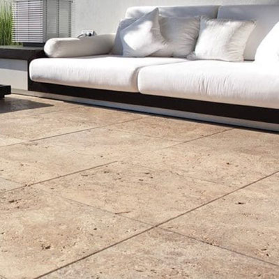 Terrace paved in travertine tiles