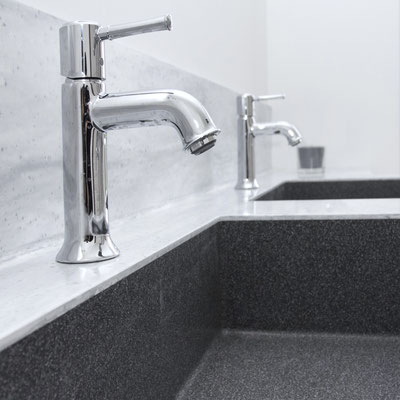 Grey acrylic solid surface vanity with 2 integrated black sinks / fabricator - Gforma