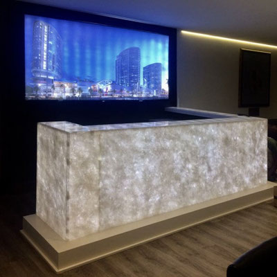 Backlit bar counter fabricated from translucent white onyx