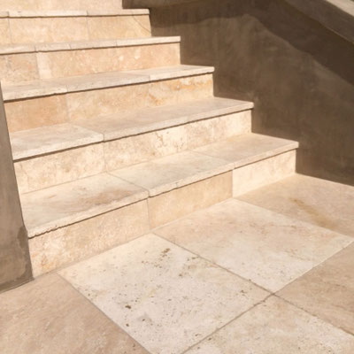 Garden stairs clad in travertine tiles