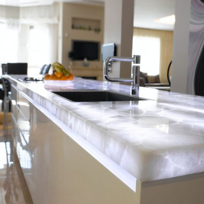 Translucent kitchen island worktop fabricated from white quartz 