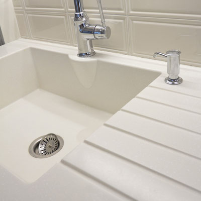 Acrylic solid surface washbasin seamlessly integrated in the kitchen countertop 
