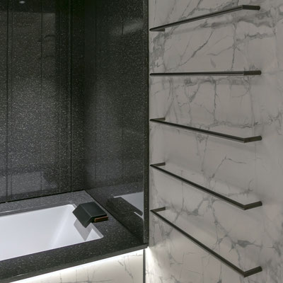 Bathtub surrounds and walls in dark acrylic stone / fabricator: Gforma