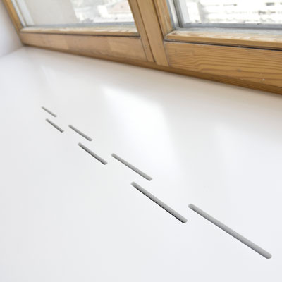 Wide acrylic stone windowsill with openings for warm air to circulate from the heater 
