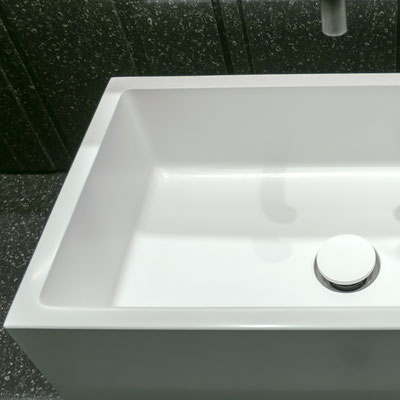 Quadrangle washbasin with straight edges from white acrylic solid surface on black solid surface top 