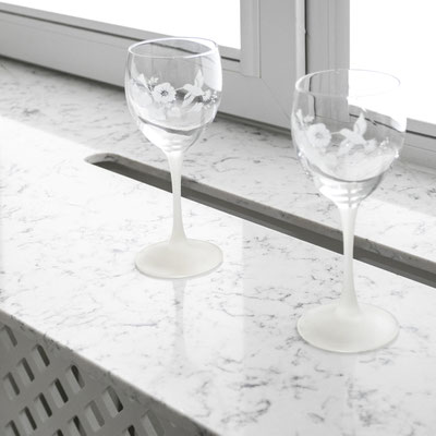 Quartz windowsill over heating battery with a hole for warm air circulation 