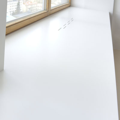 Wide solid surface window sill with cut-outs for warm air (heating battery underneath) / fabricator: Gforma