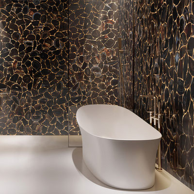 Luxurious bathroom wall fabricated from Black Diamond agate with gold seams 