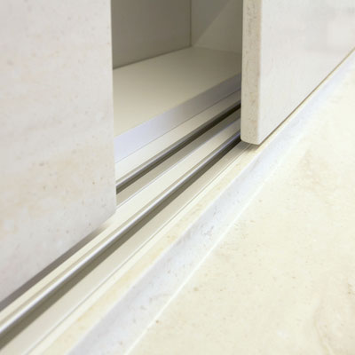 Sliding cupboard doors from acrylic solid surface performing as a splashwall in the kitchen / fabricator - Gforma