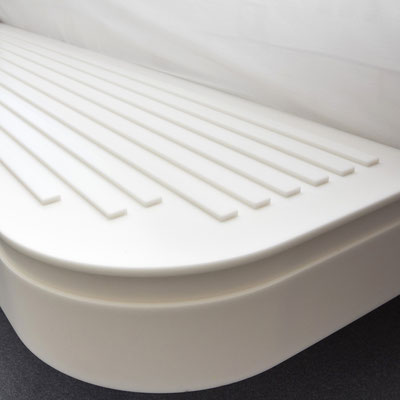 Hanging solid surface luggage shelf integrated into hotel bed / fabricator: Gforma