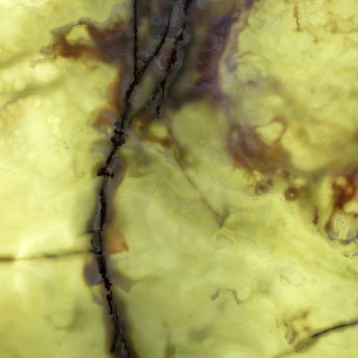 Translucent decorative wall from light green onyx with bold brown veins