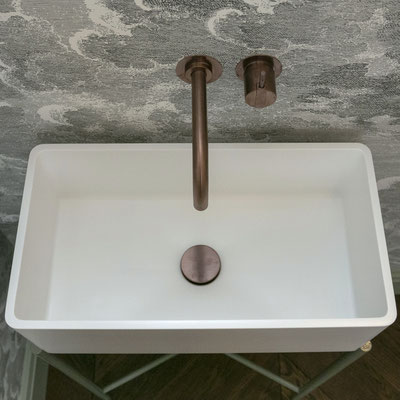 White sink fabricated from Corian Designer White solid surface placed on tailor-made metal legs / fabricator: Gforma