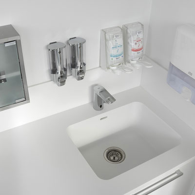 Sink with a splashback from solid surface integrated into a laboratory countertop