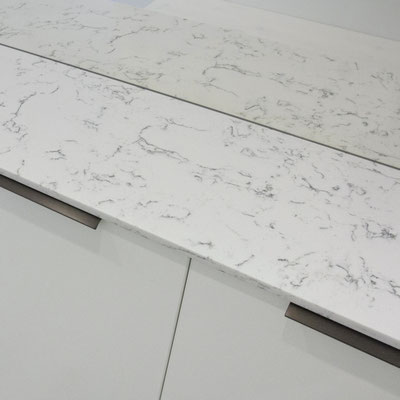 Shoe rack at the home entrance topped with engineered quartz