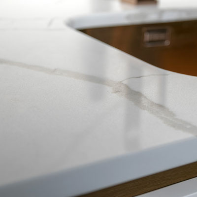 Engineered quartz countertop with integrated brass sink from Technistone 