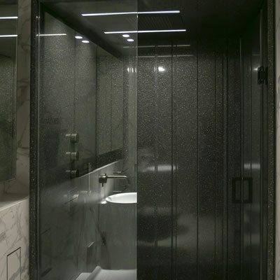 Shower walls clad in black Corian