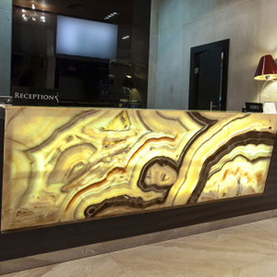 Hotel reception desk fabricated from translucent onyx slab