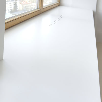 Broad windowsill as a table worktop from Corian Designer White 