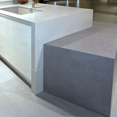 Kitchen island continuing into coffee table, the whole piece coated with Neolith sintered stone of different colours