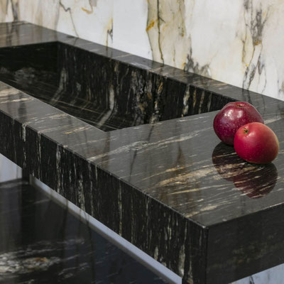 Bathroom vanity from black Cosmic Gold granite with orange veins