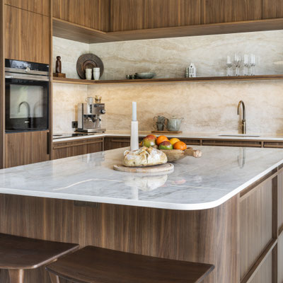 Oval-shaped kitchen island fabricated from Dekton sintered stone