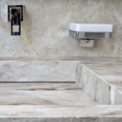 Bathroom vanity top with integrated sink in acrylic stone, matching the ceramic tile wall 