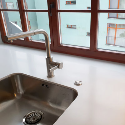 Acrylic solid surface windowsill functioning as a worktop with undermount steel sink 