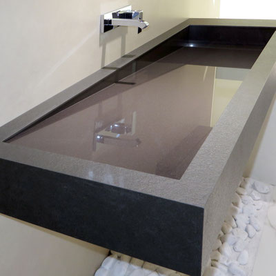 Long angled washbasin with drainage along one side in Neolith sintered stone for business centre wc