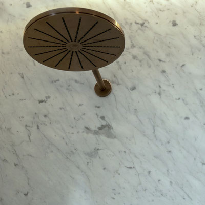 Shower wall from white marble with narrow grey veins