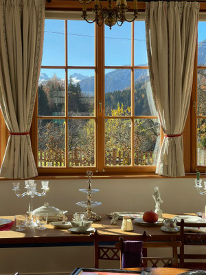 Essbereich im Gästehaus Eltz mit Panoramafenster und Blick auf die Berge