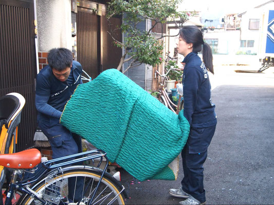 重い荷物運びは２人で協力しながらの作業