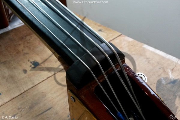 Double bass fingerboard and nut adjustment.