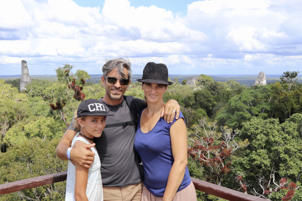 On top of the astronomical Pyramid overlooking the centre of Tikal where you see the stair temples rise out of the jungle
