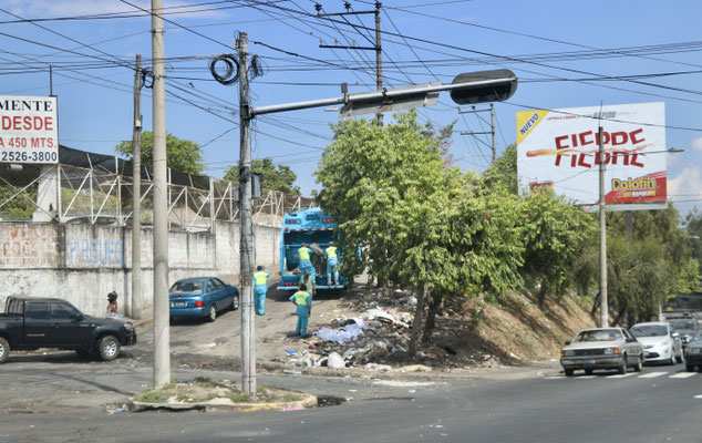 ...garbage truck picking up the rubbish in the streets..