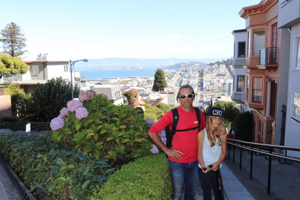 In front of the green curving Lombard Street