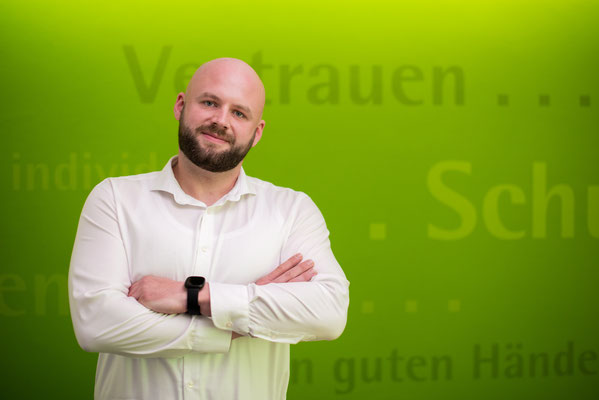 Mann mit Bart vor grünem Hintergrund. Business Porträt, aufgenommen von Sebastian Schieder - Fotograf Regensburg.