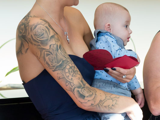 Baby auf tätowiertem Arm der Mutter – Foto von Thomas Konstandin