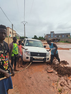 Locals helping us to free our car from the mud