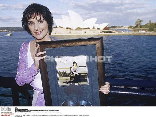 Holding an award for A Day without Rain, Sidney