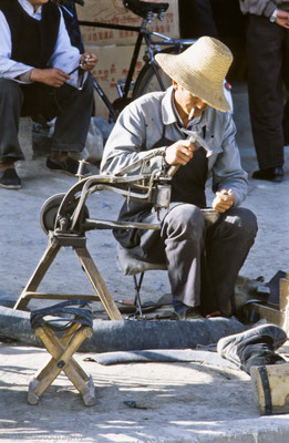 Old man working in the streets of Old Tingri, Tibet 1993