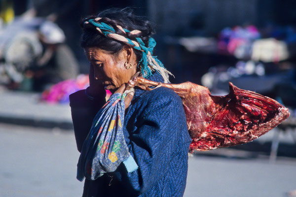Woman with meat in the streets of Shigatse, Tibet 1993