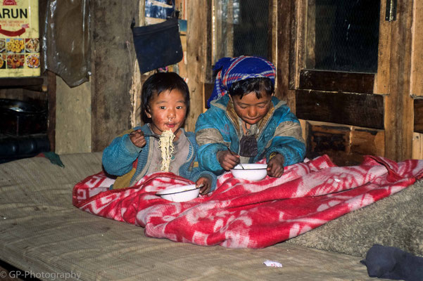 Children eating noodles