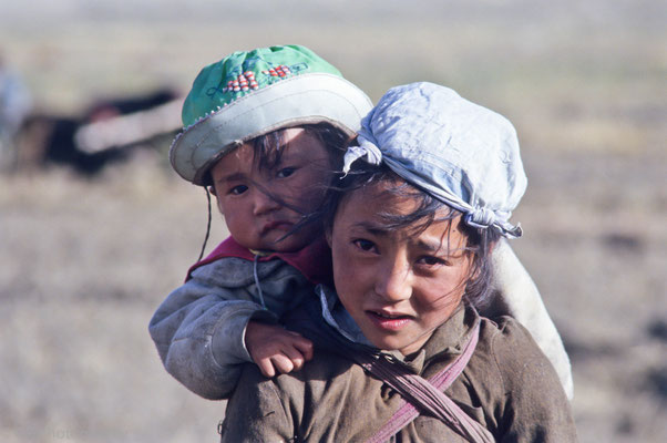 Young girl with her sister on her back, Sakya, Tibet 1993
