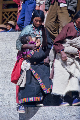 Woman breast feeding her baby, Drepung Monastery, Tibet 1993