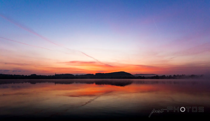 Sonnenaufgang am Wörthsee - die Sonne ist noch nicht zu sehen, taucht aber Steinebach schon in leuchtende Farben